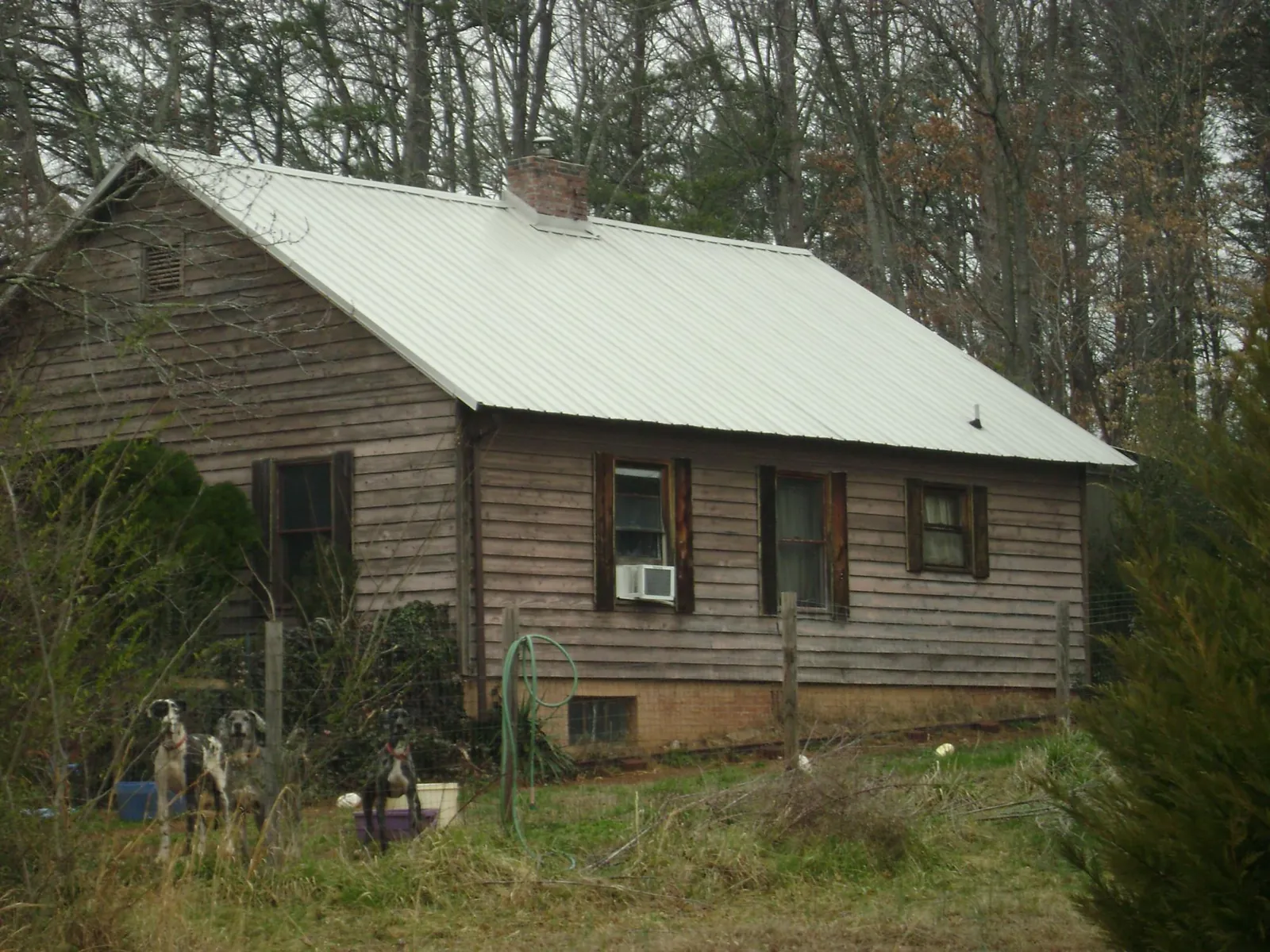 White metal roof on an old wood sided farmhouse, from a Metal Roof Installation job in Norway